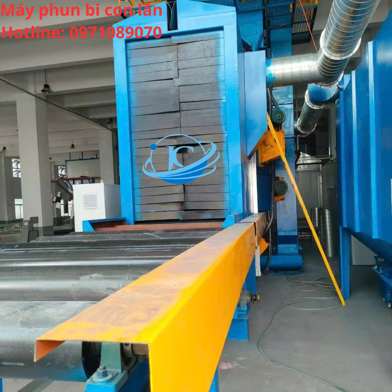 Máy Phun Bi Băng Tải Con Lăn